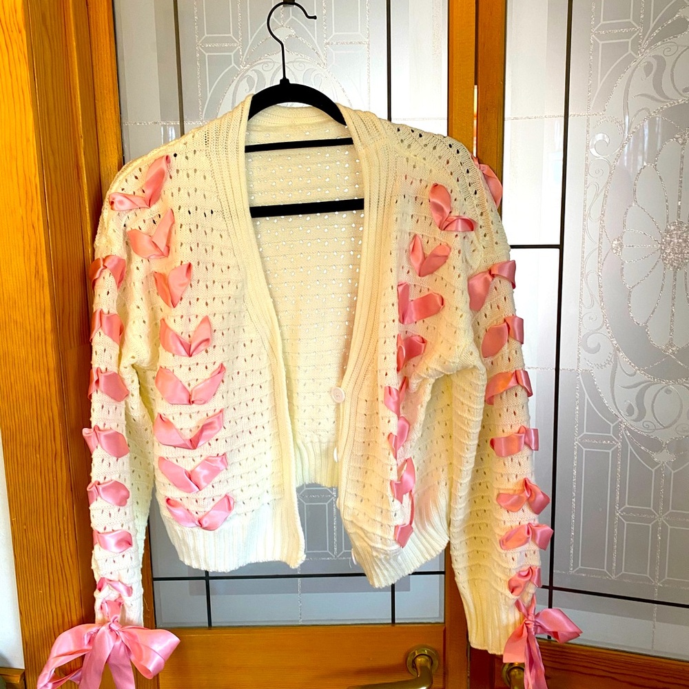 NWOT Cropped Eyelet Sweater With Accent Pink Ribbon.